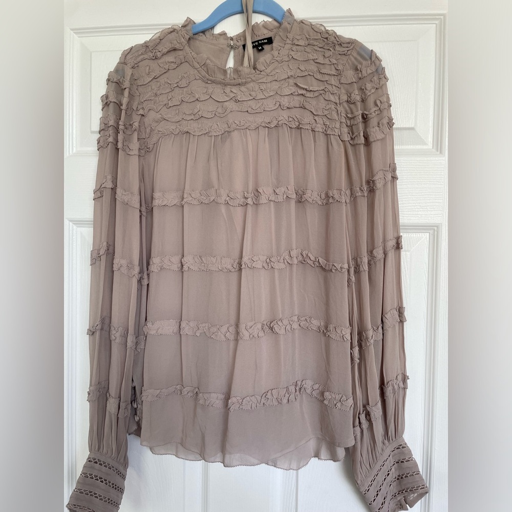Size medium women’s blouse with button and ruffle detail. Includes under shirt